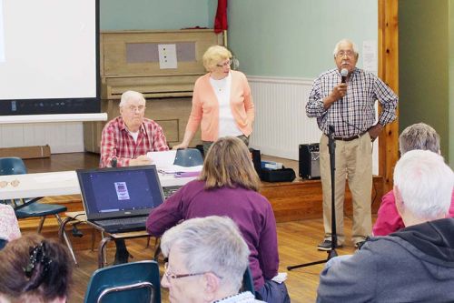 (From left) John Bolton and Eileen Flieler gave most of the presentation, but the last owner of the Kaladar Hotel, Andy Anderson, received applause when he arrived. Photo/Craig Bakay